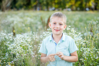 Portrait of smiling boy against plants