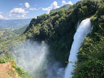 Scenic view of waterfall against sky