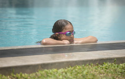 Portrait of boy swimming in pool