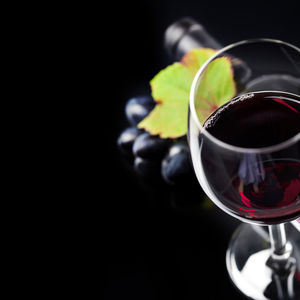 Close-up of wine glass against black background