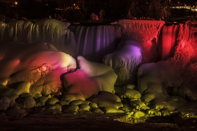 The lights illuminate the ice and water on the american falls, niagara falls, ny.