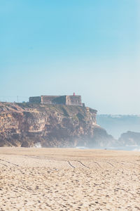 Scenic view of beach against clear sky