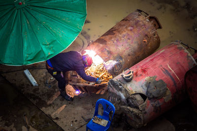 High angle view of man working at metal workshop