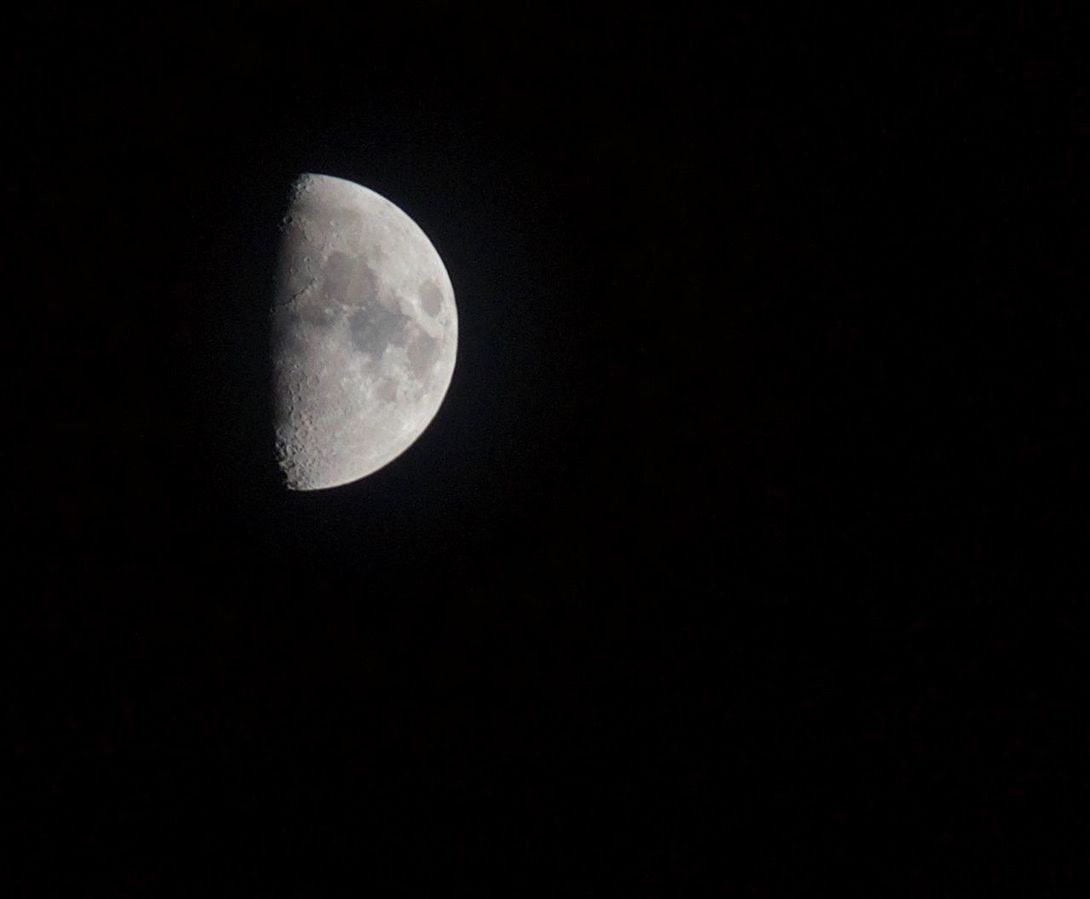 LOW ANGLE VIEW OF HALF MOON AGAINST SKY AT NIGHT