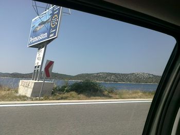 Close-up of road sign against clear sky