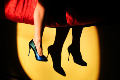 Low section of woman in high heels
