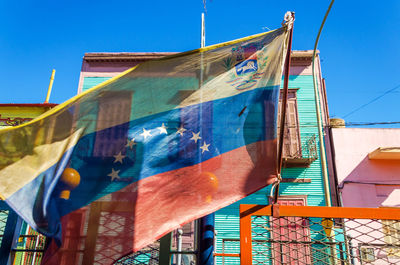 Venezuelan flag against multi colored buildings