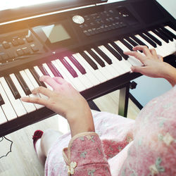 High angle view of woman playing piano