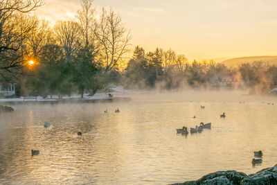 Scenic view of lake against sky during sunset