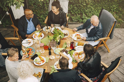 High angle view of people sitting on table