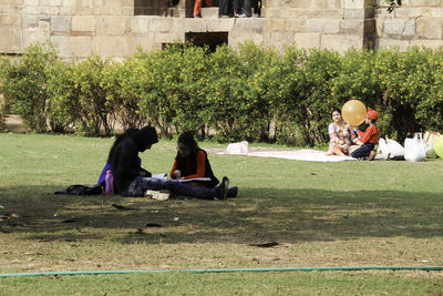 People sitting on grassland