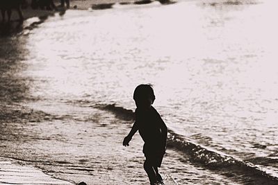 Full length of woman standing in water