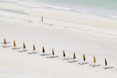 Panoramic view of wooden posts on beach during winter