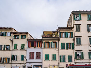 Low angle view of buildings in town against sky