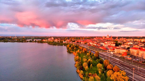 High angle view of river amidst buildings in city against sky