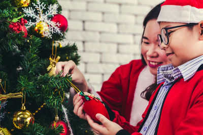 Rear view of girl holding christmas tree