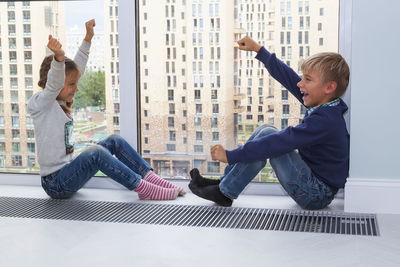 Full length of father and son in office building
