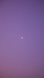 Low angle view of moon against sky at dusk