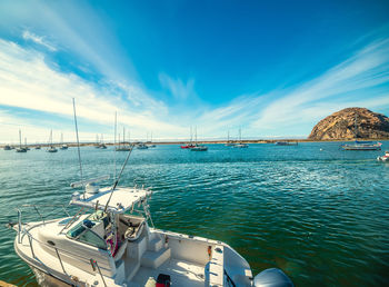 Sailboats in sea against sky