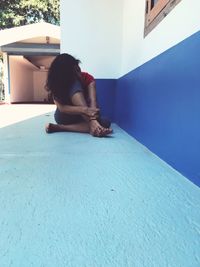 Woman sitting on a swimming pool