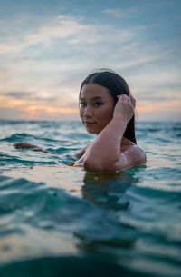 Thai woman in the water during sunset koh samui thailand