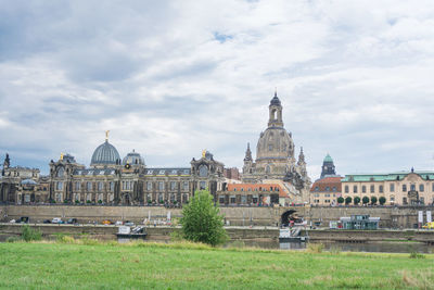 Buildings against cloudy sky