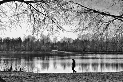 Side view of person walking by lake