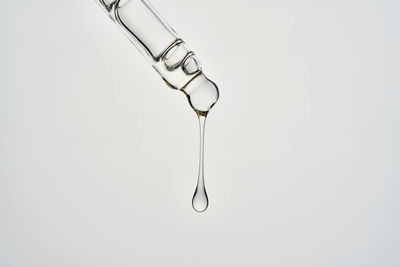 Close-up of water drop against blue sky