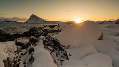 Scenic view of snowcapped mountains against sky during sunset