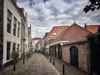 Empty footpath amidst buildings in town