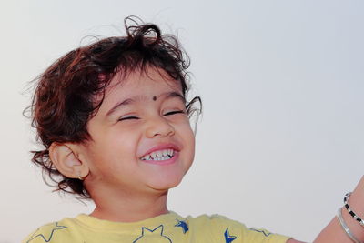 Portrait of smiling girl against clear sky