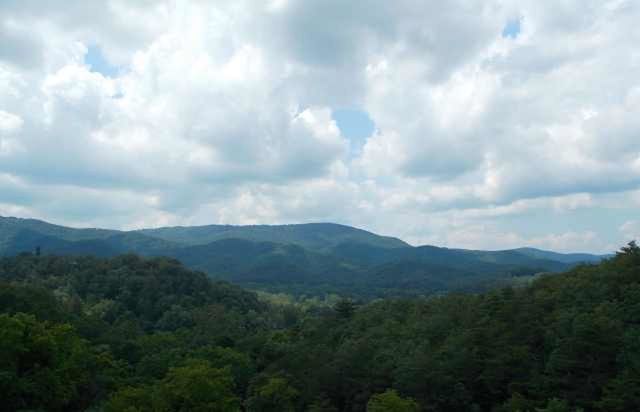 mountain, tranquil scene, tranquility, scenics, tree, sky, beauty in nature, mountain range, cloud - sky, nature, landscape, cloudy, cloud, forest, non-urban scene, idyllic, growth, lush foliage, green color, day