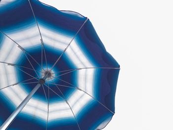 Low angle view of blue parasol against clear sky