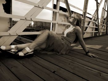 Side view of woman on wooden floor