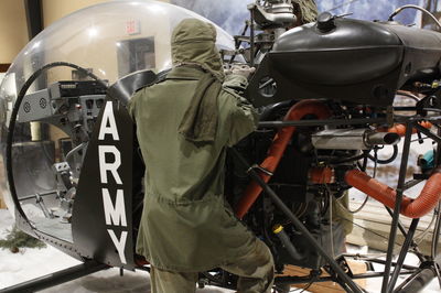 Rear view of people working on motorcycle