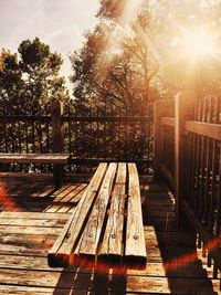Empty wooden bench by river