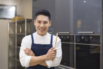 Portrait of a smiling young man holding camera