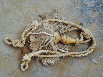 High angle view of rope tied on wall