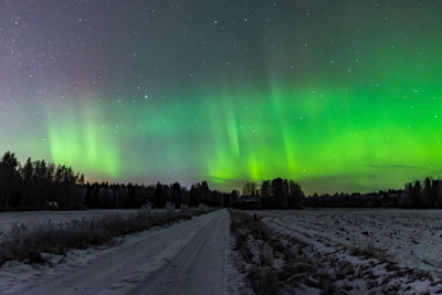 Road against sky during winter at night