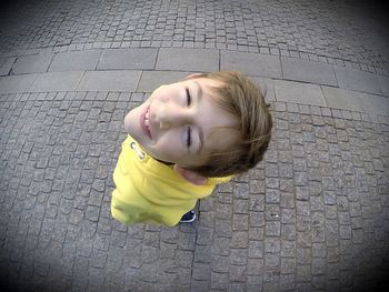 Portrait of cute boy standing on road