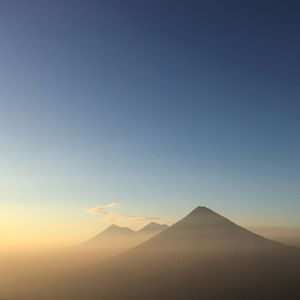 Scenic view of mountains against clear sky during sunset