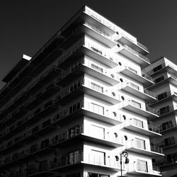 Low angle view of modern building against sky at night