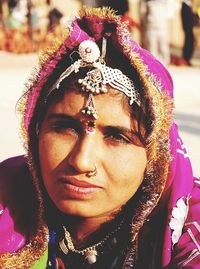 Close-up portrait of smiling young woman wearing outdoors