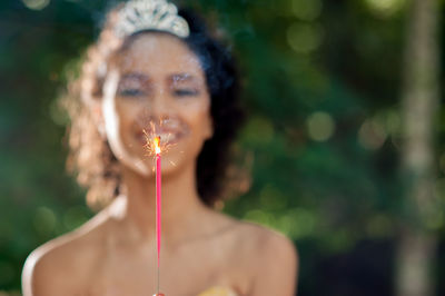 Portrait of woman holding plant