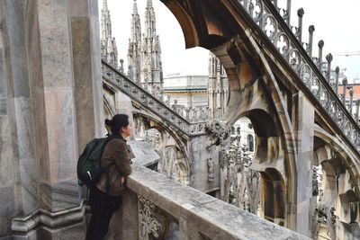 Woman standing by retaining wall at milan cathedral