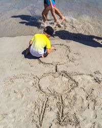 High angle view of boy playing at beach