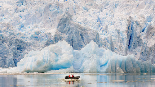 Scenic view of frozen sea against mountain