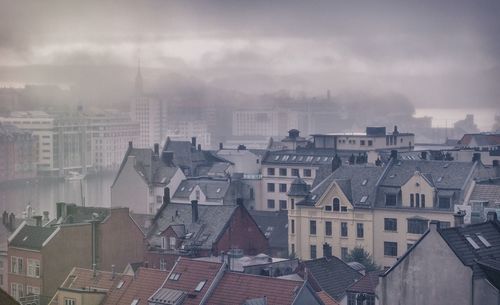 High angle view of residential buildings against cloudy sky