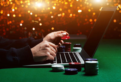 Close-up of man using smart phone on table