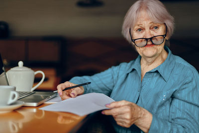 Portrait of senior woman working at cafe